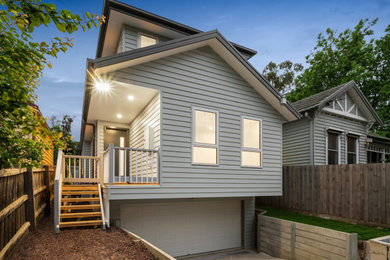 This is an example of a mid-sized modern three-storey grey house exterior in Melbourne with a grey roof.