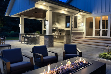 Inspiration for a traditional backyard stone landscaping in Minneapolis with a fire pit.