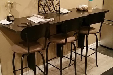 Seated home bar - small traditional single-wall carpeted seated home bar idea in Calgary with dark wood cabinets