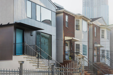 Mid-sized modern gray three-story concrete fiberboard exterior home idea in New York with a shingle roof