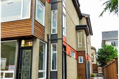 Mid-sized minimalist split-level mixed siding flat roof photo in Vancouver