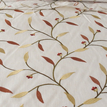 Bedroom draperies in offwhite linen blend with embroidered leaves.