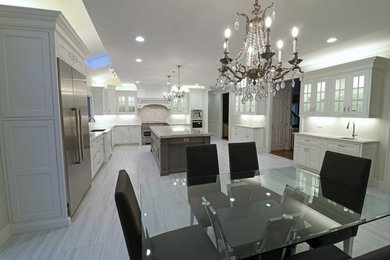 Eat-in kitchen - large l-shaped porcelain tile and gray floor eat-in kitchen idea in Boston with an undermount sink, beaded inset cabinets, white cabinets, granite countertops, white backsplash, marble backsplash, stainless steel appliances and an island