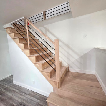 Horizontal Stair Railing with Red Oak T-Rail and Black Metal Bars