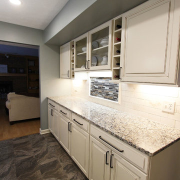 Beige Kitchen with Extra Large Island, Tile Backsplash and Granite Countertops