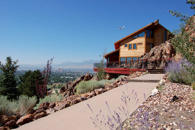 Large transitional two-story wood house exterior photo in Other with a shed roof