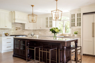 This is an example of a large l-shaped kitchen in Other with dark wood cabinets, white splashback, stainless steel appliances, an island and white worktops.