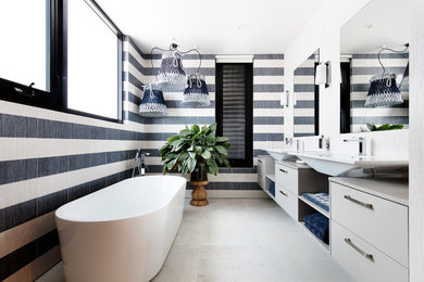 Design ideas for a large contemporary master bathroom in Melbourne with flat-panel cabinets, grey cabinets, a freestanding tub, black and white tile, ceramic tile, ceramic floors, a vessel sink, engineered quartz benchtops and beige floor.