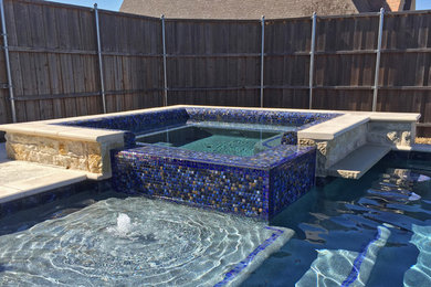 Hot tub - large mediterranean backyard custom-shaped natural hot tub idea in Dallas