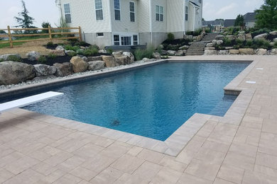 Hot tub - large eclectic backyard brick and rectangular lap hot tub idea in New York