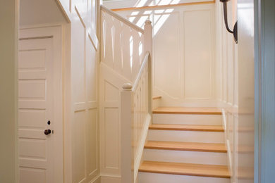 Staircase - coastal wood railing staircase idea in Providence