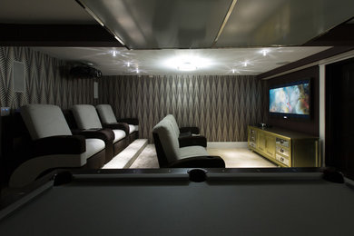 Inspiration for an enclosed home theater remodel in Miami with gray walls and a wall-mounted tv