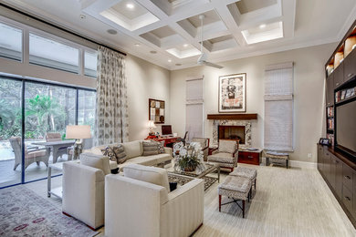 Large trendy open concept carpeted living room photo in Miami with beige walls, a standard fireplace, a stone fireplace and a media wall