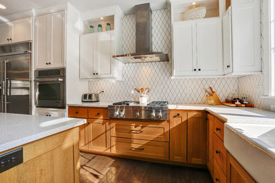 Inspiration for a transitional dark wood floor kitchen remodel in Other with a farmhouse sink, shaker cabinets, medium tone wood cabinets, white backsplash and stainless steel appliances