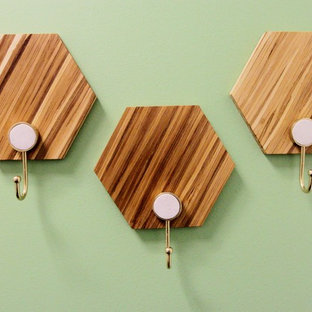 Photo of a small modern study in Los Angeles with green walls, carpet, no fireplace, a freestanding desk and grey floors.