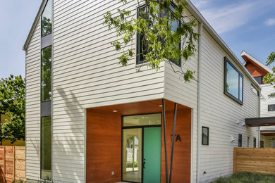 Mid-sized modern white two-story concrete fiberboard exterior home idea in Austin with a shingle roof