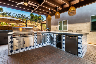 Inspiration for a timeless patio kitchen remodel in San Diego with a pergola