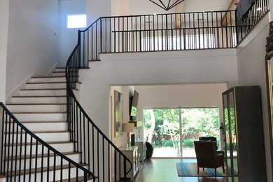 Foyer - mid-sized contemporary medium tone wood floor and brown floor foyer idea in Dallas with white walls