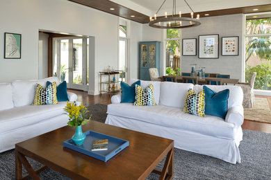 Inspiration for a huge coastal formal and enclosed medium tone wood floor and brown floor living room remodel in San Diego with gray walls, a standard fireplace, a tile fireplace and a wall-mounted tv