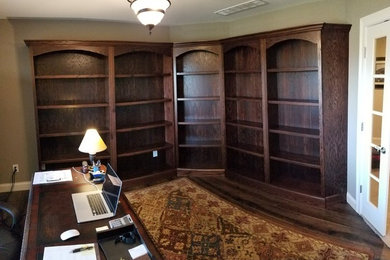 Study room - large traditional freestanding desk dark wood floor and brown floor study room idea in Louisville with beige walls