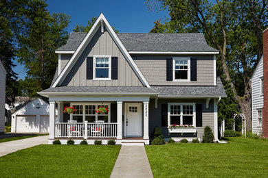 Photo of a mid-sized transitional two-storey grey exterior in Minneapolis with wood siding and a gable roof.