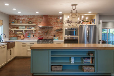 Eclectic l-shaped dark wood floor kitchen photo in San Francisco with a farmhouse sink, beige cabinets, stainless steel appliances, an island, multicolored backsplash and raised-panel cabinets