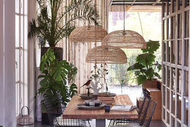 Design ideas for a large tropical dining room in Brisbane with concrete floors.