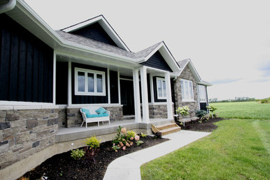 Inspiration for a mid-sized craftsman black one-story mixed siding exterior home remodel in Toronto with a shingle roof