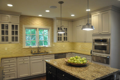 Large elegant u-shaped medium tone wood floor enclosed kitchen photo in San Francisco with an undermount sink, recessed-panel cabinets, white cabinets, granite countertops, yellow backsplash, subway tile backsplash, stainless steel appliances and an island