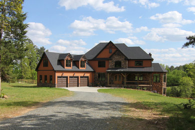 This is an example of an expansive arts and crafts three-storey brown exterior in Raleigh with mixed siding.