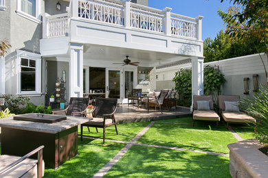 Inspiration for a large timeless backyard patio remodel in San Diego with a fire pit and a roof extension
