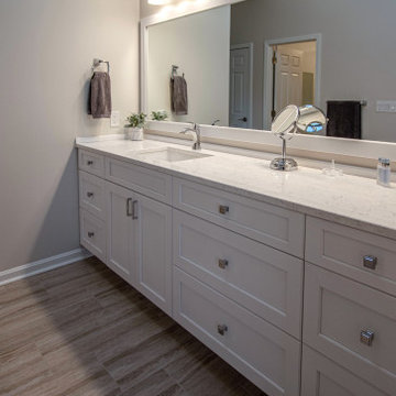 White Vanity with Freestanding Tub and Tiled Shower with Closet Storage