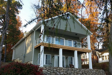 Large elegant gray two-story vinyl exterior home photo in Other with a shingle roof