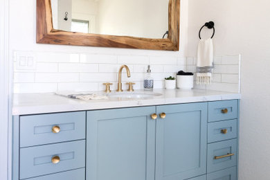 Example of a mid-sized cottage 3/4 white tile and subway tile travertine floor, brown floor and single-sink bathroom design in Phoenix with shaker cabinets, turquoise cabinets, a one-piece toilet, white walls, an undermount sink, quartz countertops, white countertops, a niche and a built-in vanity