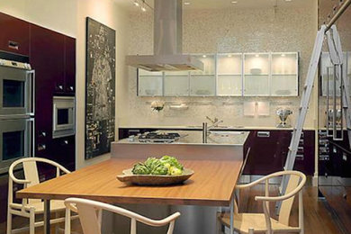 Example of a mid-sized u-shaped medium tone wood floor eat-in kitchen design in New York with flat-panel cabinets, dark wood cabinets, stainless steel appliances and an island