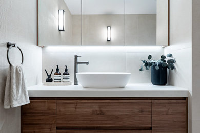 Photo of a mid-sized contemporary bathroom in Sydney with flat-panel cabinets, dark wood cabinets, a corner tub, an alcove shower, a two-piece toilet, beige tile, a vessel sink, beige floor, a hinged shower door, grey benchtops, a single vanity and a built-in vanity.