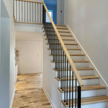 Timeless Transitional Staircase with Iron Balusters & White Risers