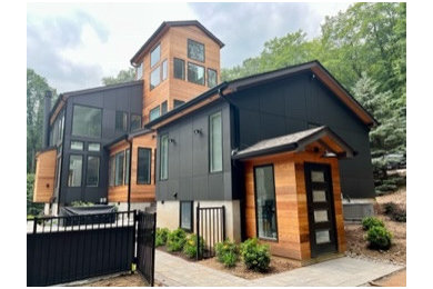 Inspiration for a huge modern mixed siding house exterior remodel in New York
