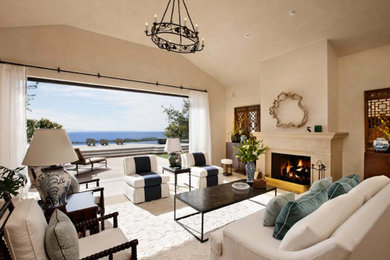 Elegant ceramic tile living room photo in Santa Barbara with beige walls, a standard fireplace and a stone fireplace