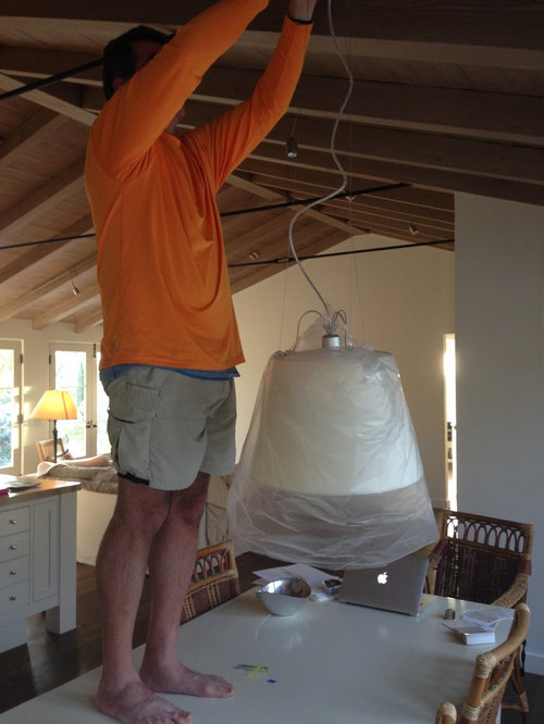 How high should a light with a shade be hung over a table?