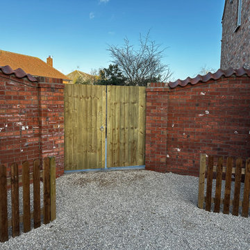 Ledged and Braced Double Gates Hung Between Brick Walls