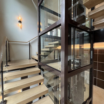 Project #136 | Modern Floating Staircase Encircling Glass Elevator