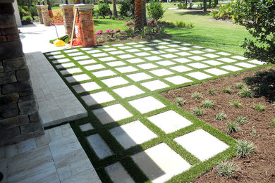 This is an example of a mid-sized modern full sun backyard brick landscaping in Toronto.