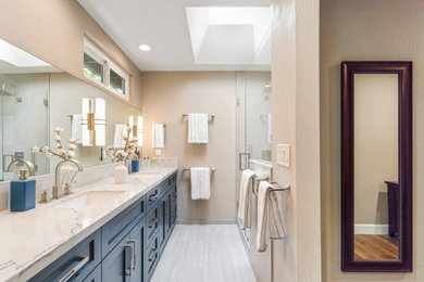 Example of a mid-sized transitional master gray tile and porcelain tile porcelain tile, gray floor and double-sink bathroom design in San Francisco with shaker cabinets, blue cabinets, a one-piece toilet, gray walls, an undermount sink, quartz countertops, a hinged shower door, white countertops, a niche and a built-in vanity