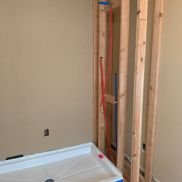Install new acrylic shower pan, run water supply lines and drain