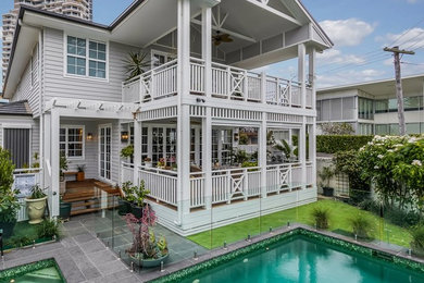 Photo of a mid-sized beach style home design in Brisbane.