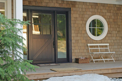 Inspiration for a beach style entryway in Vancouver with a glass front door.