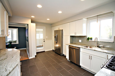 Eat-in kitchen - large transitional galley ceramic tile eat-in kitchen idea in Detroit with an undermount sink, shaker cabinets, white cabinets, marble countertops, gray backsplash, glass tile backsplash and stainless steel appliances
