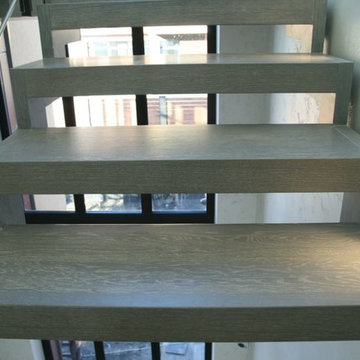Modern metal stair covered by patina oak