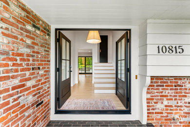 Example of a large entryway design in Portland with a black front door
